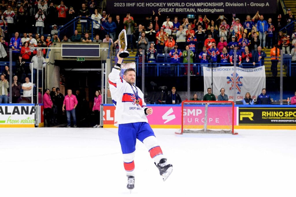 Jonathan Phillips lifts the men's World Championship Division I Group A trophy in his final game for Great Britain in Nottingham in 2023